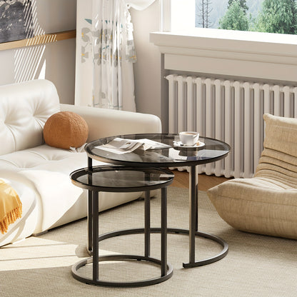 Set of Two Nesting Glass Coffee Tables, Featuring Small Round Designs Suitable for Living Rooms Or Bedrooms, with a Modern Industrial Style And a Black Metal Frame.